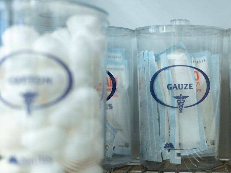 clear containers with gauze and cotton balls