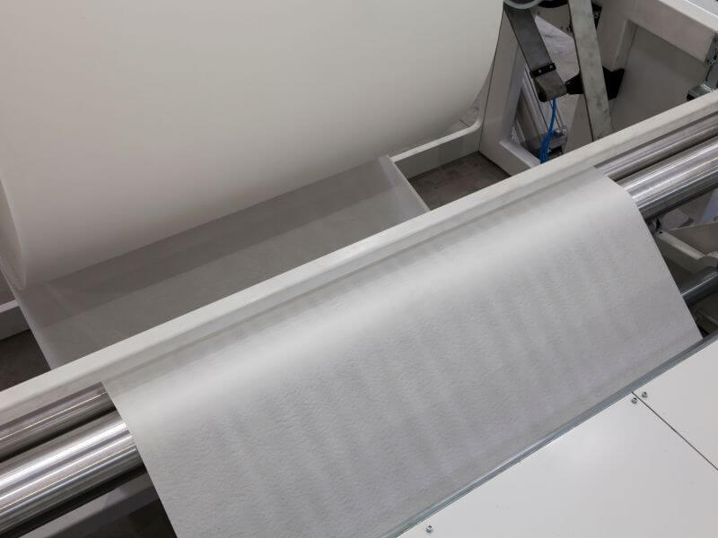 roll of paper moving through machine